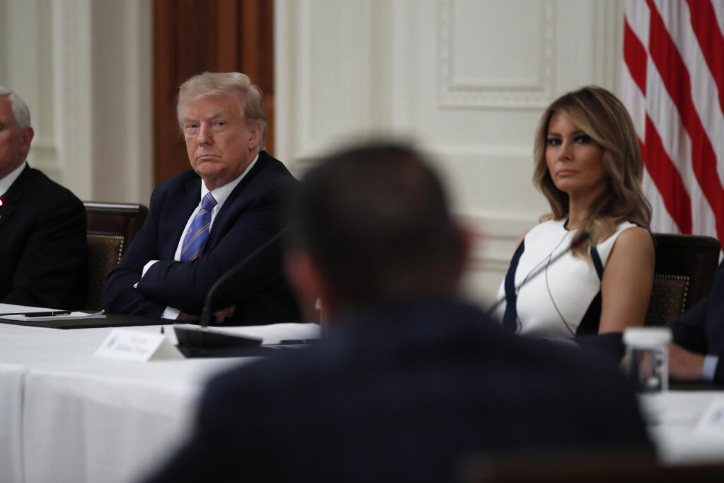 President Donald Trump and first lady Melania Trump listen during a "National Dialogue on Safely Reopening America's Schools" event in the East Room of the White House, Tuesday, July 7, 2020, in Washington. (Alex Brandon / Associated Press)