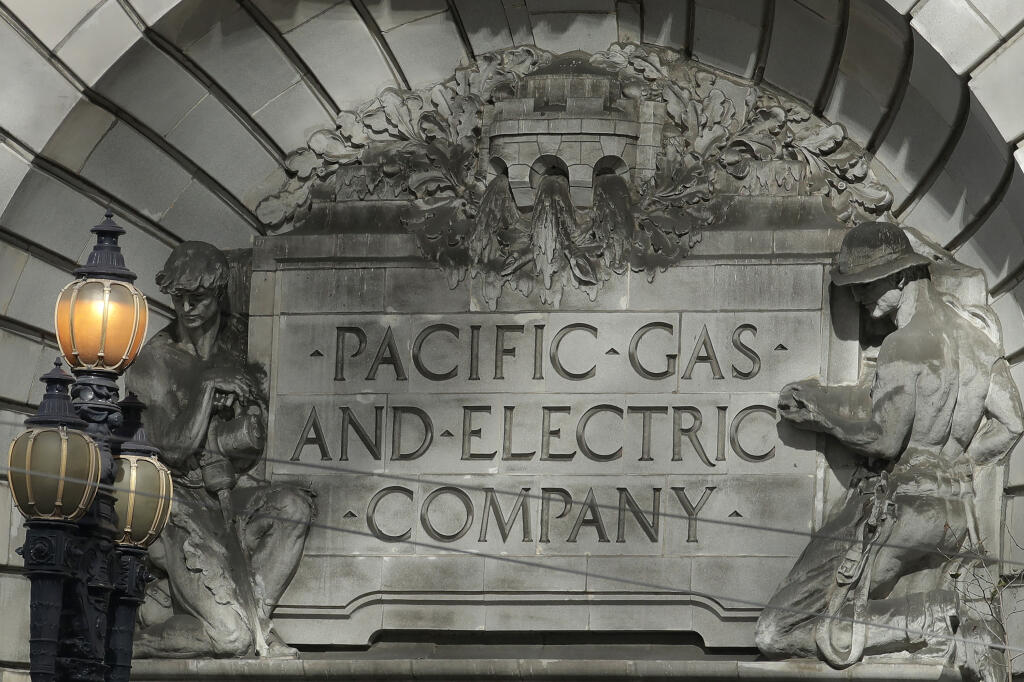 FILE - In this Oct. 10, 2019, file photo, a Pacific Gas & Electric sign is shown outside of a PG&E building in San Francisco. (AP Photo/Jeff Chiu, File)