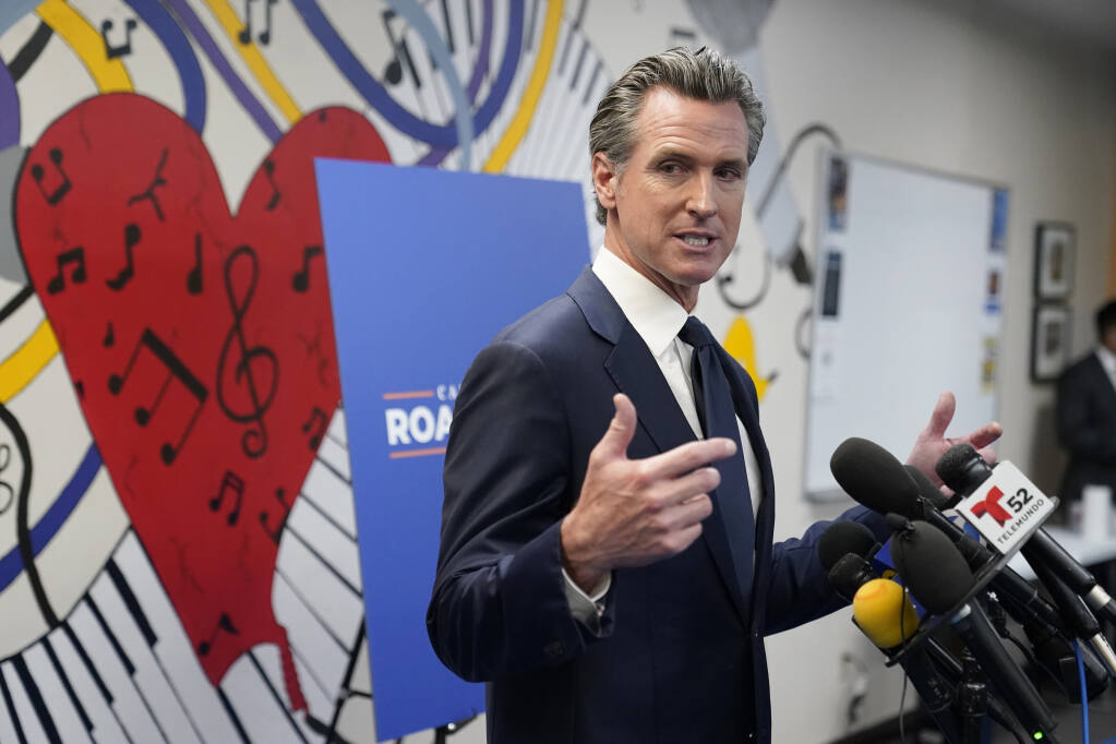 Gov. Gavin Newsom fields questions after a July 13 rally in Los Angeles. He is the subject of a Sept. 14 recall election. (MARCIO JOSE SANCHEZ / Associated Press)