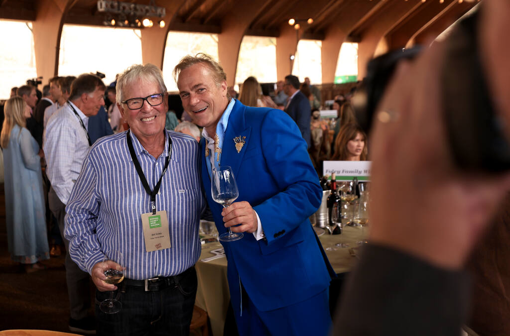 Bill Foley and Jean-Charles Boisset pose for an event photographer prior to the beginning of the Sonoma County Wine Auction, Saturday, Sept. 17, 2022, at Chalk Hill Winery near Windsor. (Kent Porter / The Press Democrat) 2022