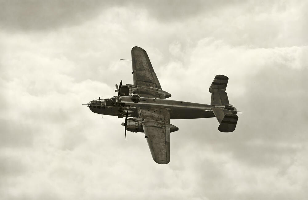 World War II era bomber in flight. (Ivan Cholakov / Shutterstock)
