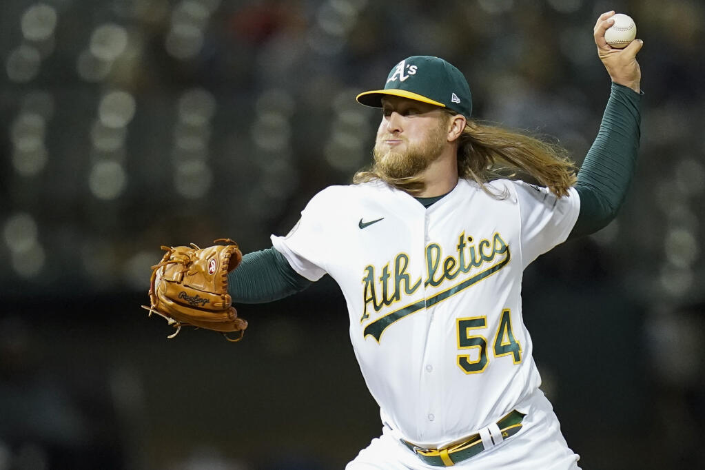 The Oakland Athletics' Kirby Snead pitches against the Miami Marlins during the ninth inning in Oakland, Calif., Tuesday, Aug. 23, 2022. (AP Photo/Godofredo A. Vásquez)