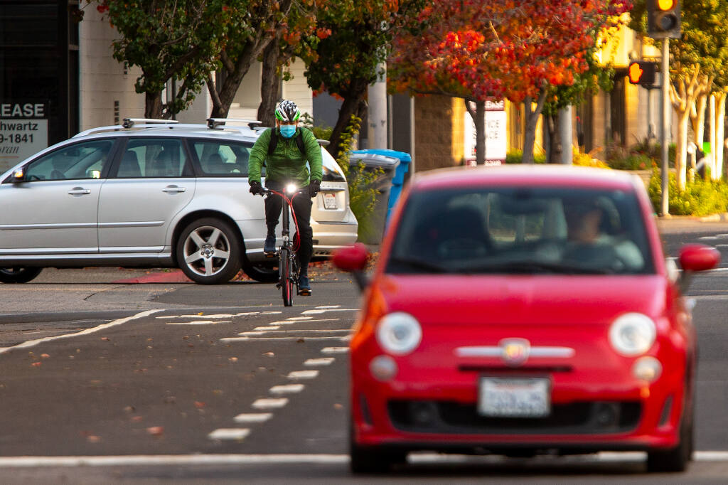 A cyclist pedals along a new bicycle lane on E Street in Santa Rosa on Wednesday, Nov. 18, 2020. Measure M transportation funds were used to help complete the project. (Alvin A.H. Jornada / The Press Democrat)