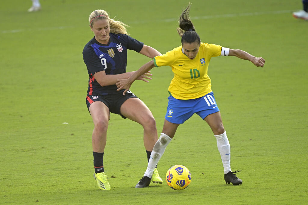 United States midfielder Lindsey Horan, left, and Brazil midfielder Marta compete for a ball during the second half of a 2021 SheBelieves Cup game in Orlando, Florida. (Phelan M. Ebenhack / ASSOCIATED PRESS)