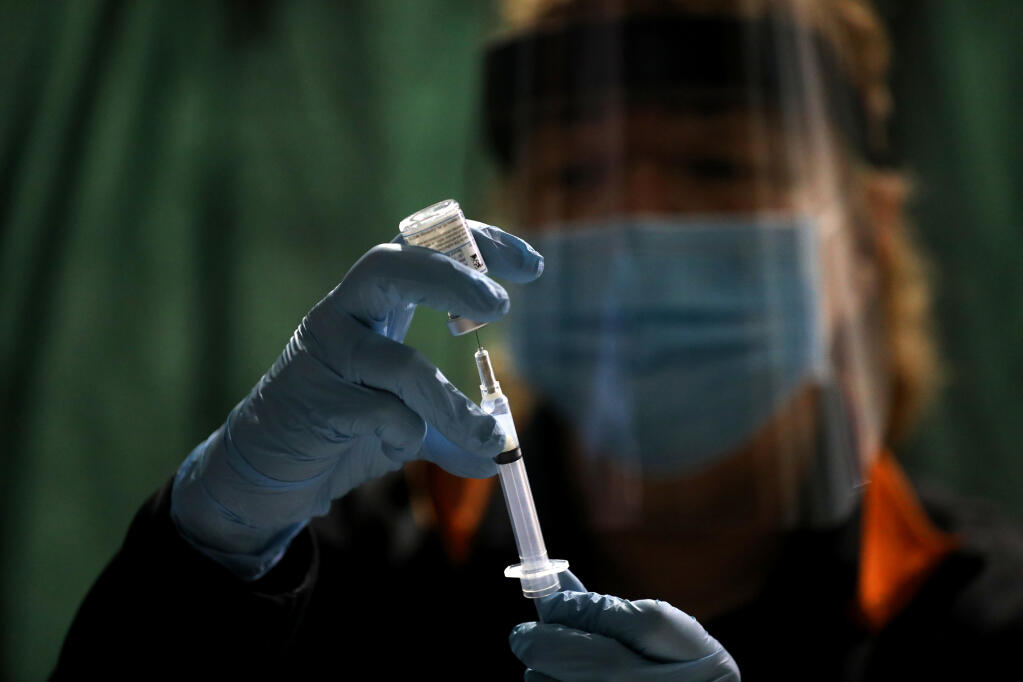 Ruth Ann Rowan prepares a COVID-19 vaccination shot at a clinic in the Tehama County town of Corning. (GARY CORONADO / Los Angeles Times)