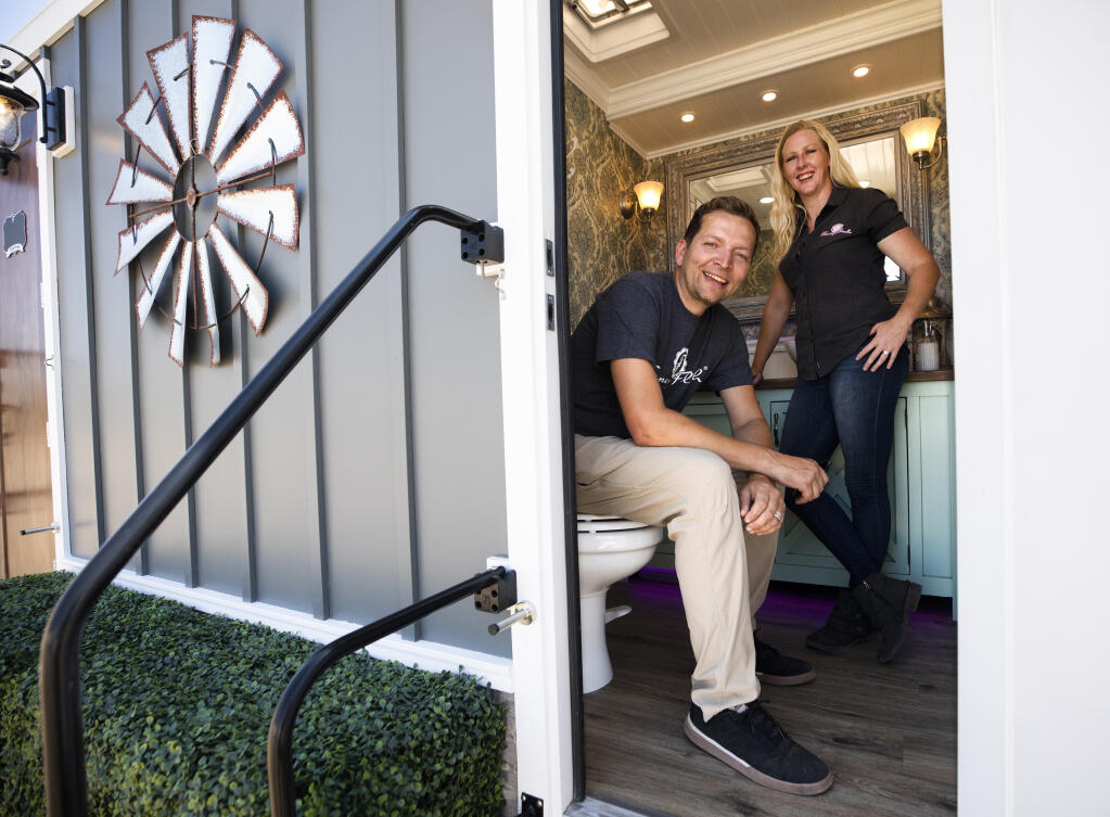 Roman, right, and Heather Seiffert in their estate Fancy Flush portable bathrooms used for weddings and events throughout Sonoma County. The fancy portages-potty is in the running for the top 10 best commercial bathrooms in the U.S. competition for the Santa Rosa company.  (Photo by John Burgess/The Press Democrat)