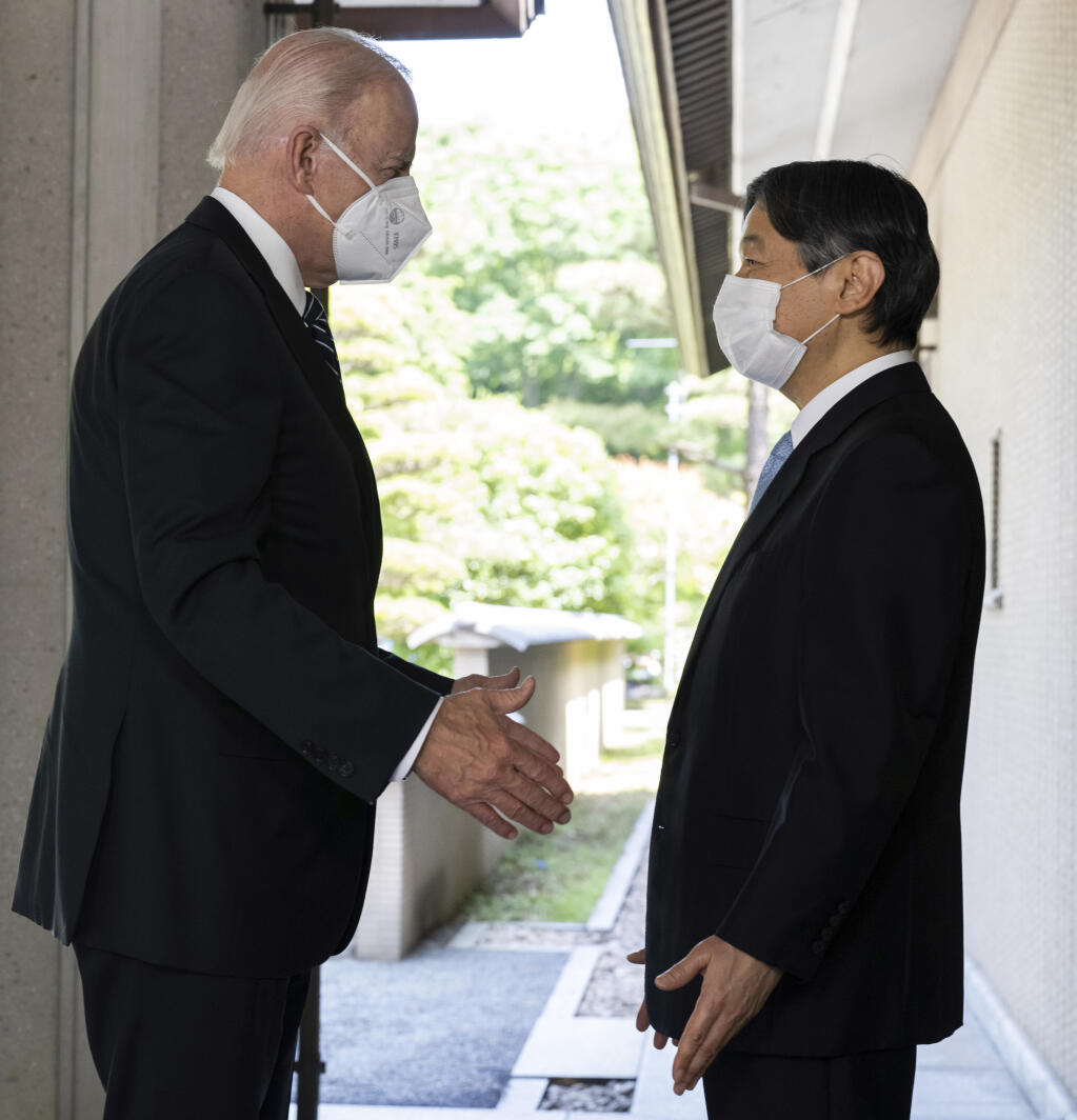 Japan's Emperor Naruhito, right, greets U.S. President Joe Biden prior to their meeting at the Imperial Palace in Tokyo Monday, May 23, 2022. (Saul Loeb/Pool Photo via AP)