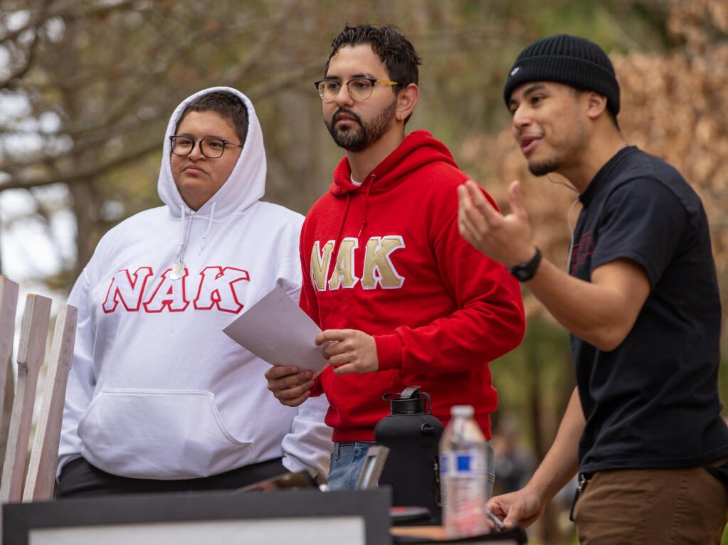 Nu Alpha Kappa fraternity members, from left Luis Gutierrez and Sean Lopez work the fraternity’s booth celebrating the 35 anniversary of the Latino fraternity at the Sonoma State University quad Tuesday, Feb. 14, 2023, in Rohnert Park. (Chad Surmick/The Press Democrat)