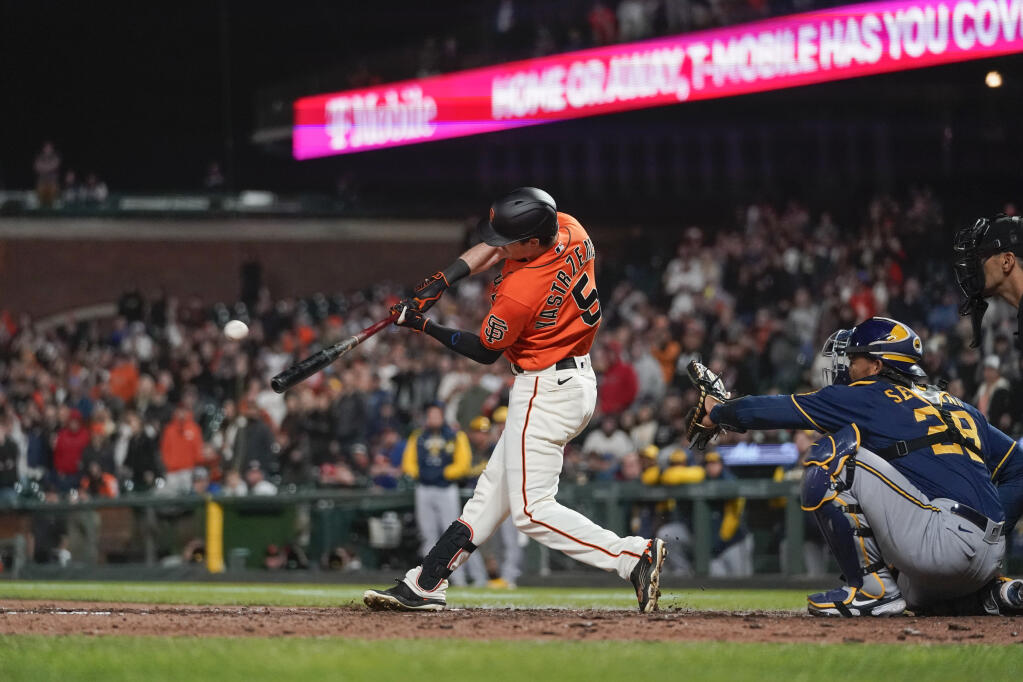 The Giants’ Mike Yastrzemski hits a grand slam against the Milwaukee Brewers during the ninth inning in San Francisco, Friday, July 15, 2022. The Giants won 8-5. (Godofredo A. Vásquez / ASSOCIATED PRESS)