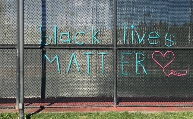 This sign, made of tulle woven into the chain link fence, is typical of the messages the Kindness Committee has been leaving around town for the last several months.