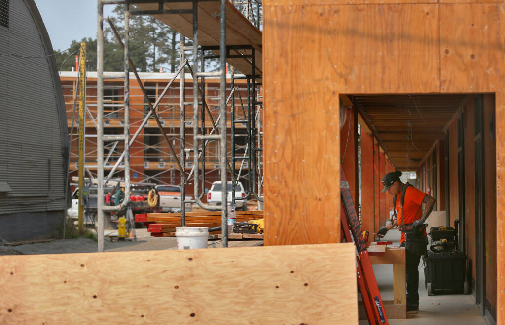 Construction work continues at the Sage Commons affordable housing project along College Avenue, at Cleveland Avenue, in Santa Rosa on Friday, August 6, 2021.  (Christopher Chung/ The Press Democrat)
