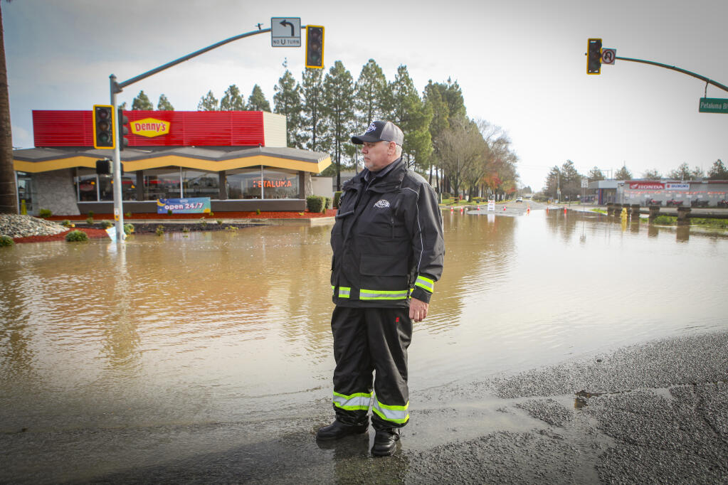 Don Horner, assistant operations manager for the city of Petaluma, stands guard at the closed intersection of North Petaluma Boulevard and Stony Point Road on Monday, January 9, 2023. (CRISSY PASCUAL/ARGUS-COURIER STAFF)