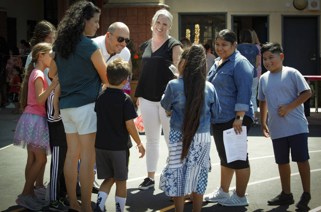 Petaluma City School’s Superintendent Matthew Harris introduces his family to another incoming McDowell School family Monday, Aug. 15, as the school’s new principal, Ruth Miller, greets students and their families. (CRISSY PASCUAL/ARGUS-COURIER)