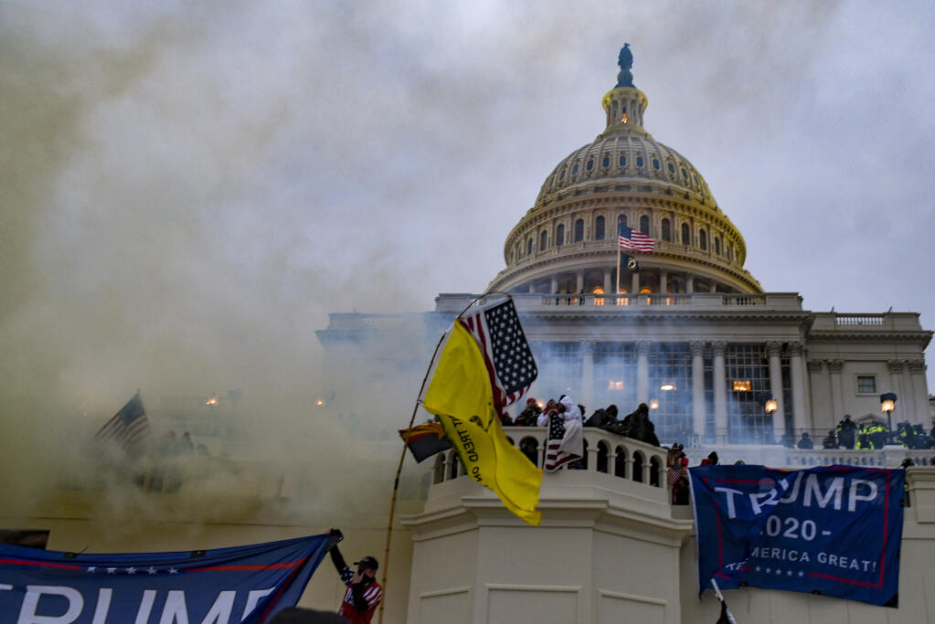 Supporters of former President Donald Trump attack the U.S. Capitol in Washington, Jan. 6, 2021. Tucker Carlson has fanned doubts about the 2020 election and often cast those who stormed the Capitol as victims: innocent citizens entrapped by scheming Democrats.