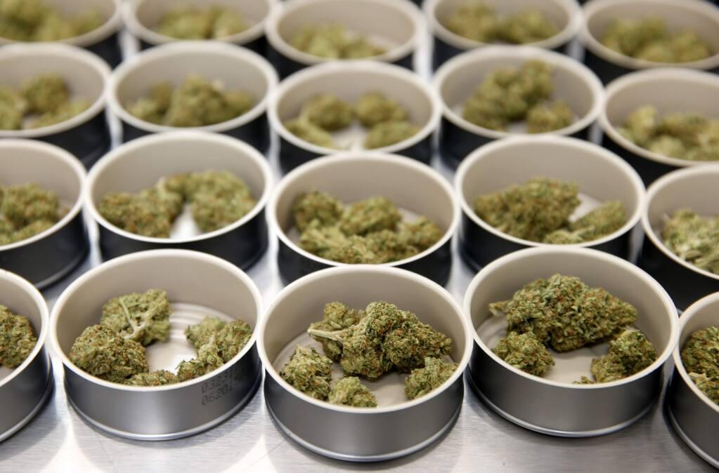 Tins of cannabis await dispensing at Mercy Wellness in Cotati. Sonoma is proposing a 4-percent maximum tax on commercial cannabis. (Beth Schlanker/Press Democrat)