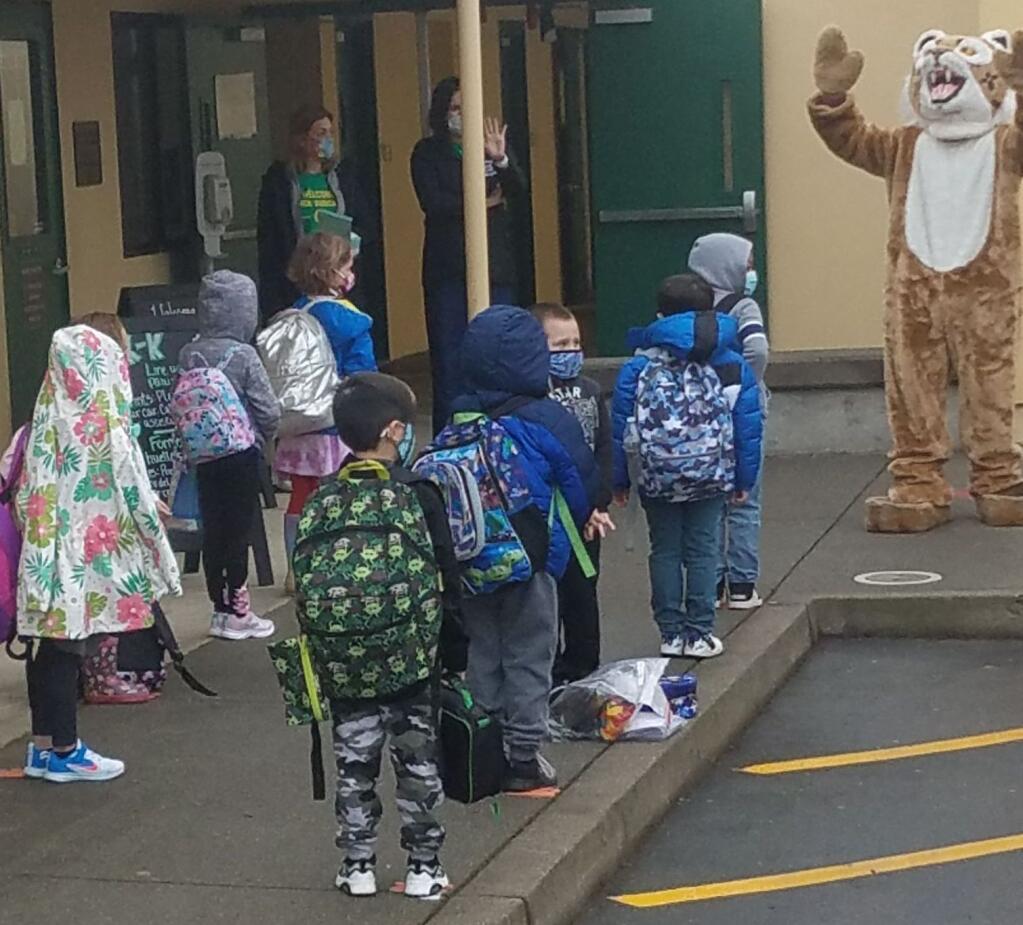 Two Rock School Bobcat mascot welcomes back kindergarteners and first grader. Note flowers a student has brought for his teacher. (JOHN JACKSON/ARGUS-COURIER STAFF)