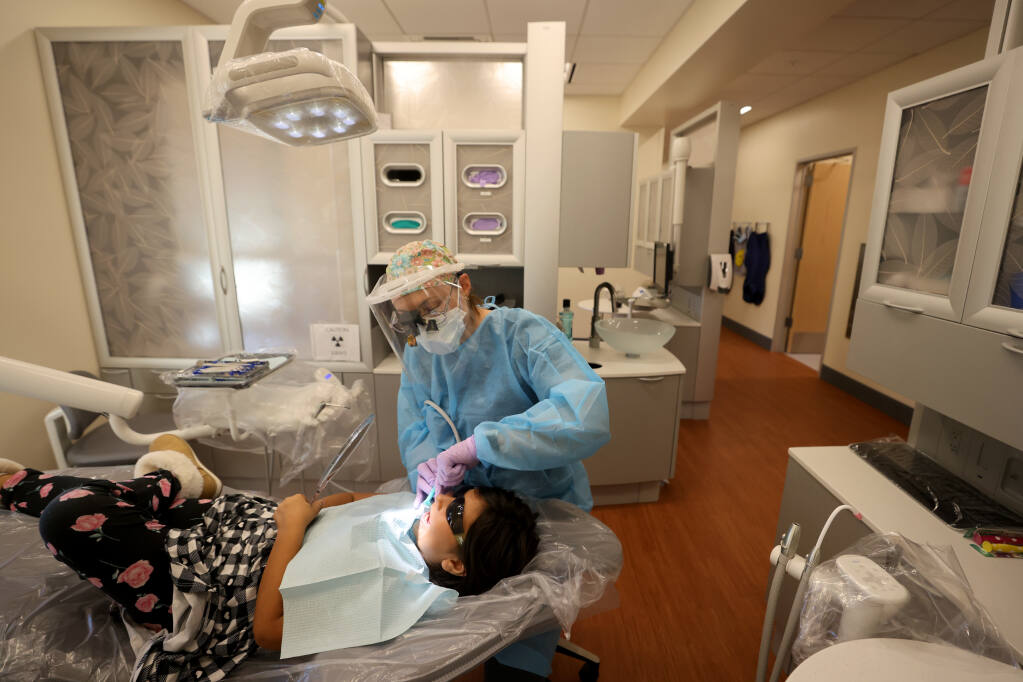 Mayra Barragan, 6, gets her teeth cleaned by dental hygienist Jaime Dahl at the new Russian River Health and Wellness Center in Guerneville, Calif., Wednesday, Nov. 23, 2022. (Beth Schlanker/The Press Democrat)