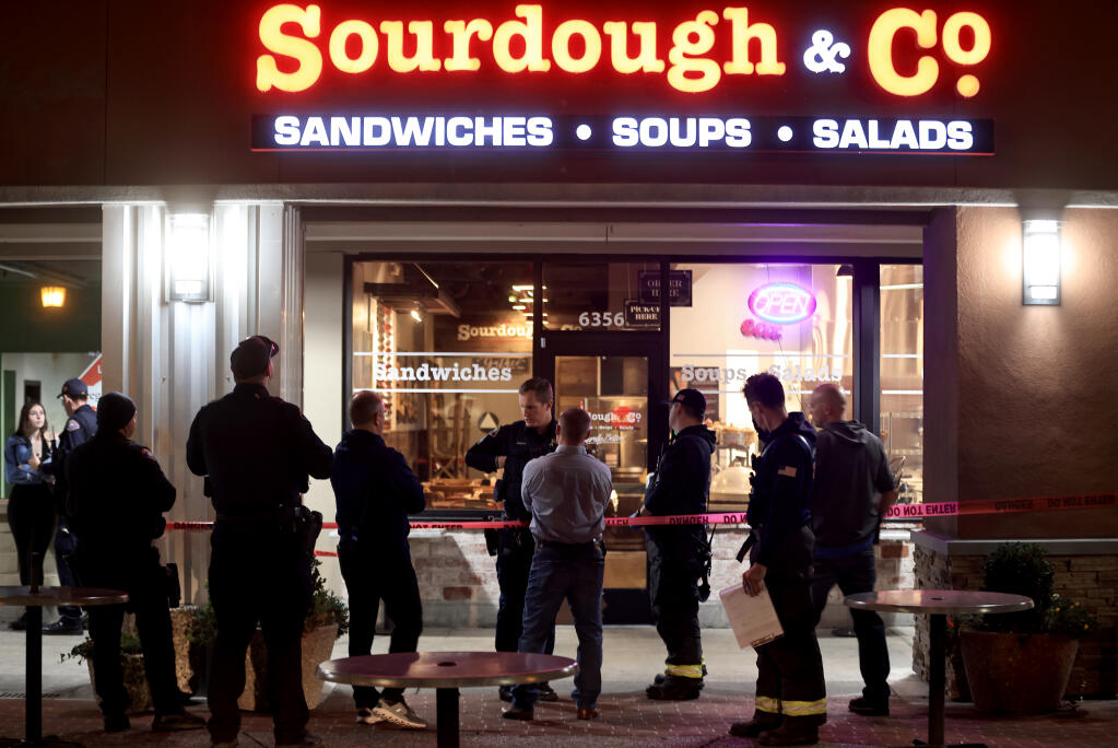 Rohnert Park Department of Public Safety officers, detectives and firefighters gather at the scene of a shooting, where one person was shot inside Sourdough and Co., next door to Safeway on Commerce Blvd., Sunday, Nov. 13, 2022 in Rohnert Park. (Kent Porter / The Press Democrat) 2022