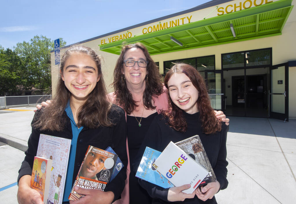 From left, Lily Gelb, principal Maite Iturri and Victoria Hernandez with a selection culturally inclusive book in front of the El Verano Elementary School multi-purpose room on Friday, May 14, 2021.(Photo by Robbi Pengelly/Index-Tribune)