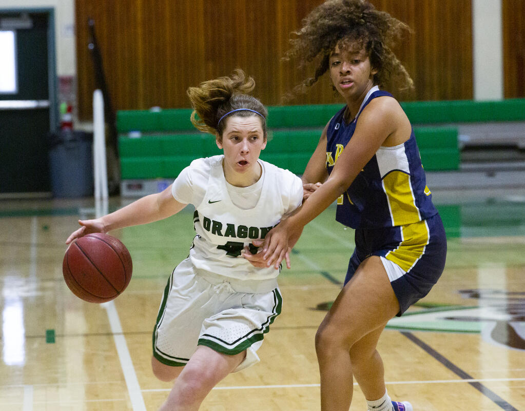 Lily Hoban (40) drives around a defender in the varsity game at Pfeiffer Gym on Wednesday, April 21, 2021. The Dragon girls won 48-42 against the Napa Grizzlies (Photo by Robbi Pengelly/Index-Tribune)