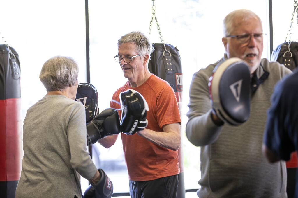 Rock Steady class members Karen Lloyd, from left, Mark Sloan and Larry Wofford work on conditioning drills at Ringtime Fitness in Santa Rosa during their weekly Tuesday morning meeting for a custom Parkinson’s disease workout at the club March 26, 2024. (Chad Surmick / The Press Democrat)