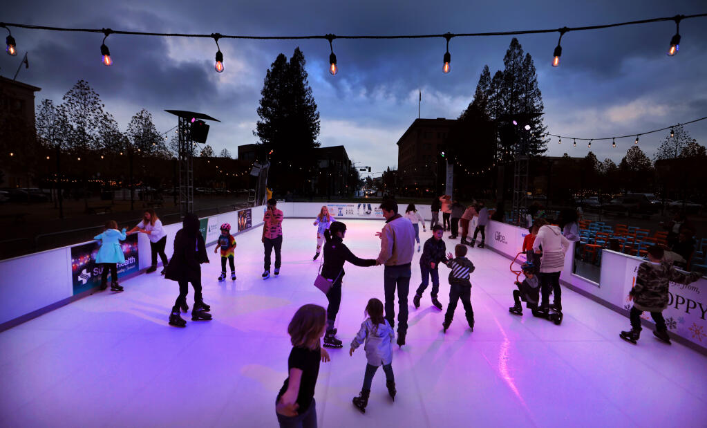 At dusk, the newly installed synthetic ice skating rink is up and running for the general public, Friday, Nov. 19 2021 at Old Courthouse Square in Santa Rosa. (Kent Porter / The Press Democrat) 2021