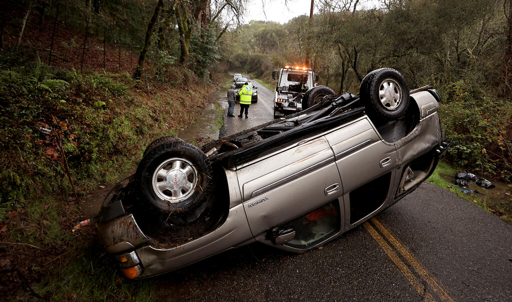 Slick roads and waterlogged shoulders contributed to a rollover on Mark West Station Road, Saturday, Jan. 20, 2024, near Windsor. The driver was not injured. (Kent Porter / Press Democrat)