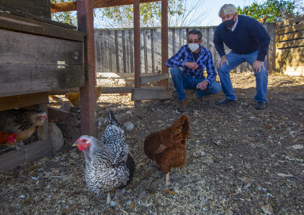 Kory Stradinger, right,  executive director of Sweetwater Spectrum, and Chris Hoover, facilities manager, with the chickens that supply eggs to the residents of the housing facility. (Photo by Robbi Pengelly/Index-Tribune)