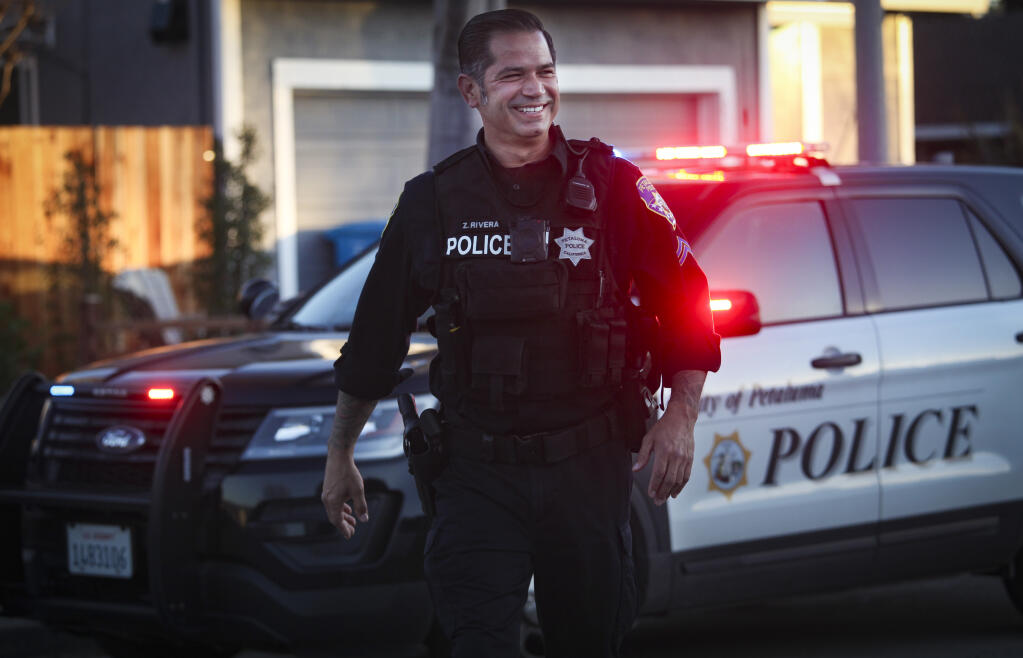 Officer Zilverio “Zeus” Rivera of the Petaluma Police Department smiles at the scene of a call Tuesday, Feb. 23, 2021, in east Petaluma. Rivera was recently named the department’s Officer of the Year. (CRISSY PASCUAL/ARGUS-COURIER STAFF)