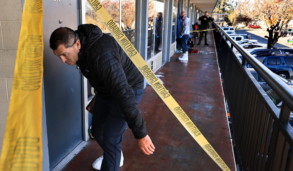 Sonoma County Sheriff's Office personnel investigate the scene of a homicide on the second floor of the Palms Inn just outside the Santa Rosa city limits on Santa Rosa Avenue, Tuesday, Dec. 13, 2022. (Kent Porter/The Press Democrat)