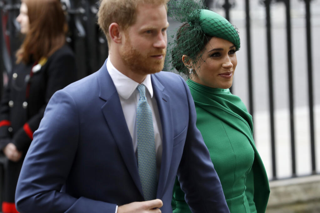 FILE - In this Monday, March 9, 2020 file photo, Britain's Harry and Meghan the Duke and Duchess of Sussex arrive to attend the annual Commonwealth Day service at Westminster Abbey in London. Prince Harry has repaid 2.4 million pounds ($3.2 million) in British taxpayers’ money that was used to renovate the home intended for him and his wife Meghan before they gave up royal duties. A spokesman on Monday, Sept. 7, 2020 Harry has made a contribution to the Sovereign Grant, the public money that goes to the royal family. (AP Photo/Kirsty Wigglesworth, file)