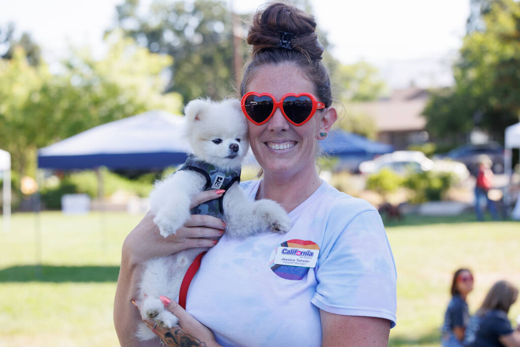 Jessica Tahsler holds up her dog, Gus, during the Humane Society’s 12th Annual Walk for Animals in Yountville Community Park on August 7, 2023. (Abraham Fuentes/For The Press Democrat)