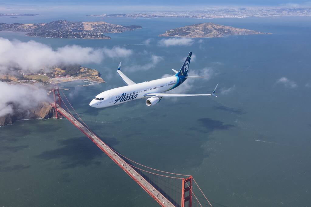 An Alaska Airlines Boeing 737-900ER plane flies over the Golden Gate Bridge in San Francisco. (Chad Slattery Photography) May 25, 2016