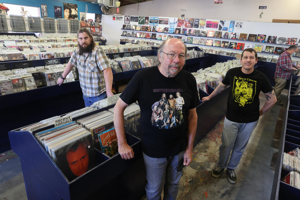 The co-owners of The Next Record Store are Doug Jayne, center, and his wife Barrett (not pictured), his son Ethan Jayne, right, and Gerry Stumbaugh.  Doug Jayne was also co-owner of The Last Record Store.  (Christopher Chung/ The Press Democrat)