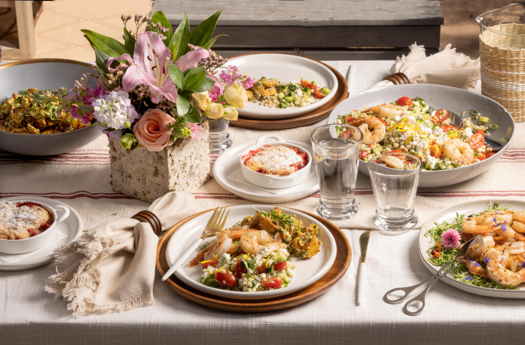 A summer feast with Fresh Corn, Cherry Tomato and Feta Salad with Grilled Prawns, Roasted New Potato Salad and Strawberry Lemon Cobbler from private chef Veronica Eicke, Wednesday, May 17, 2023. (John Burgess / The Press Democrat / Styling Susie Snetsinger)