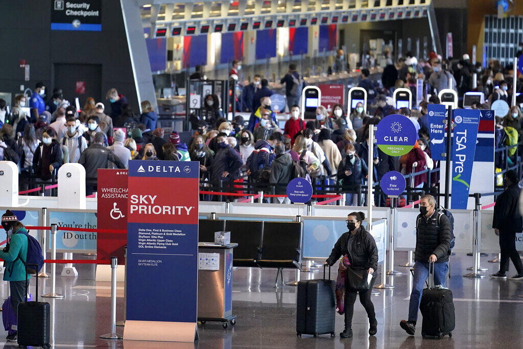 Travelers enter security checkpoints at Logan International Airport,in Boston on the day before Thanksgiving. (STEVE SENNE / Associated Press)