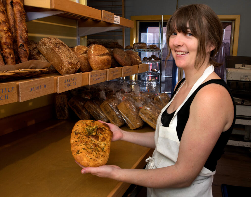 Owner Jessie Frost holds a rosemary focaccia loaf at Nightingale Breads, Sunday, Oct. 9, 2022, in Forestville. (Darryl Bush/For The Press Democrat)