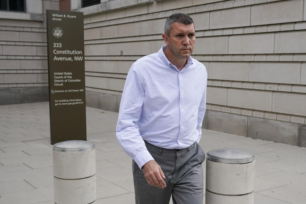 Washington Metropolitan Police Department Lt. Shane Lamond departs federal court after pleading not guilty to obstruction of justice and other charges, Friday, May 19, 2023, in Washington. Lamond is accused of lying about leaking confidential information to a leader of the far-right Proud Boys extremist group and obstructing an investigation after group members destroyed a Black Lives Matter banner in Washington. (AP Photo/Patrick Semansky)