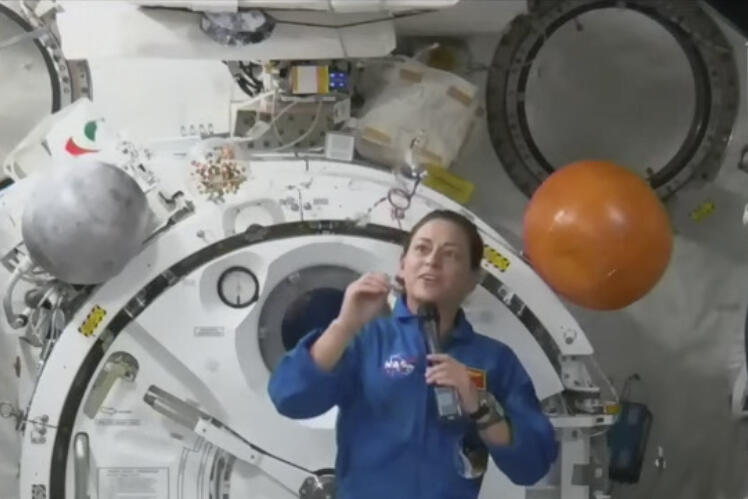 In this image from video made available by NASA, astronaut Nicole Mann shows her dreamcatcher during an interview on Wednesday, Oct. 19, 2022. The first Native American woman in space said Wednesday that she’s overwhelmed by the beauty and delicacy of Mother Earth, and is channeling “positive energy” as her five-month mission gets underway. (NASA via AP)