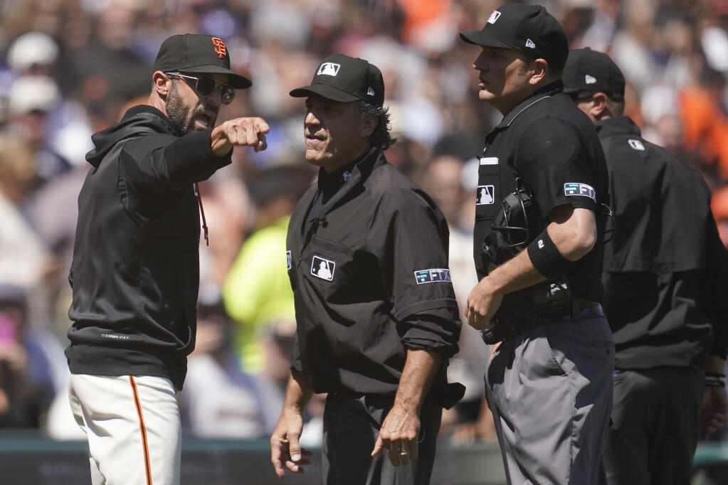 Giants manager Gabe Kapler, left, makes a point to umpire Phil Cuzzi, second from left, after being ejected during the sixth inning against the Los Angeles Dodgers Thursday, Aug. 4, 2022, in San Francisco. (Jeff Chiu / ASSOCIATED PRESS)