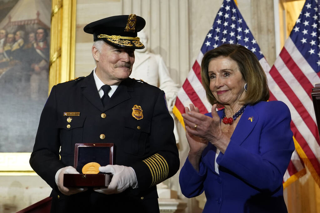 Speaker of the House Nancy Pelosi of Calif., applauds U.S. Capitol Police Chief J. Thomas Manger, during a Congressional Gold Medal ceremony honoring law enforcement officers who defended the U.S. Capitol on Jan. 6, 2021, in the U.S. Capitol Rotunda in Washington, Tuesday, Dec. 6, 2022. (AP Photo/Alex Brandon)