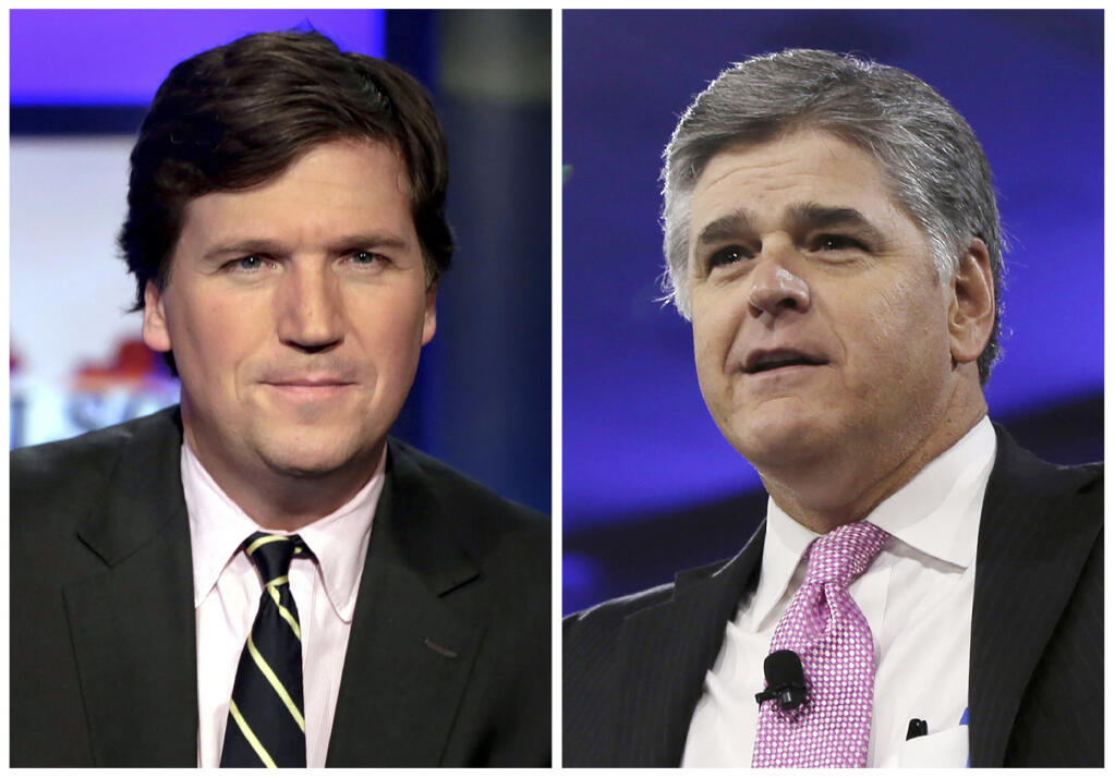 This combination photo shows, from left, Tucker Carlson, host of "Tucker Carlson Tonight," and Sean Hannity, host of "Hannity" on Fox News. (AP Photo/File)