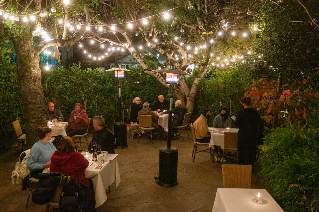 Customers have dinner in the courtyard of Ca'Bianca Ristorante Italiano in Santa Rosa on Thursday, Dec. 10, 2020. Businesses in Sonoma County will have to weather another stay-at-home order intended to reduce the spike in COVID-19 cases. (Alvin A.H. Jornada / The Press Democrat)
