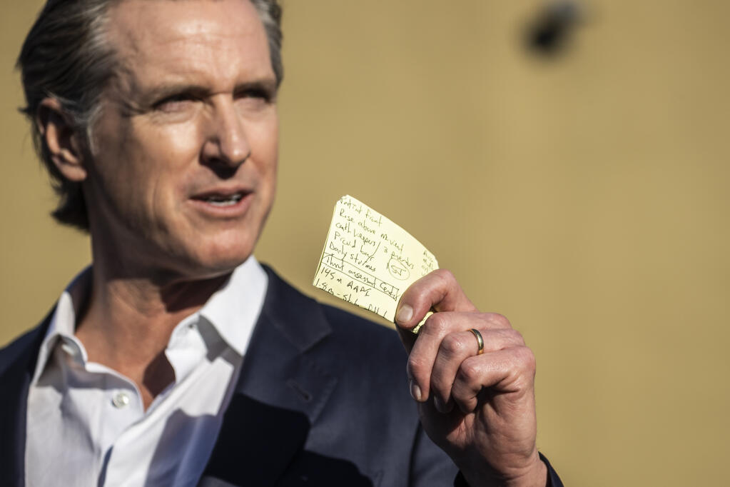 Gov. Gavin Newsom holds a handwritten note of talking points from previous mass shootings during a press conference in response to a mass shooting in Half Moon Bay, Calif. Tuesday, Jan. 24, 2023. Seven people were killed and one person was injured in two separate locations nearby on Monday. The suspect, 66-year-old Chunli Zhao, was arrested in what investigators believe to be workplace violence. (Stephen Lam/San Francisco Chronicle via AP)