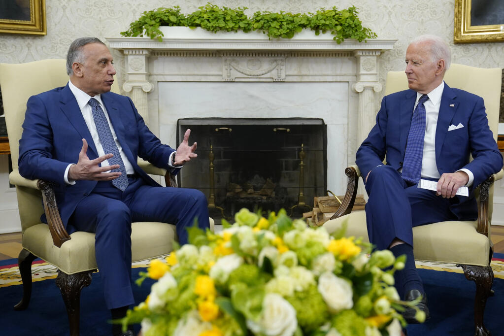 President Joe Biden listens to Iraqi Prime Minister Mustafa al-Kadhimi during their meeting Monday at the White House in Washington. (SUSAN WALSH / Associated Press)