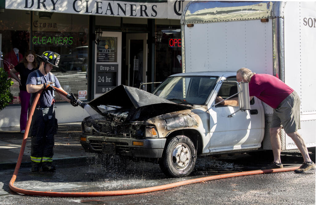 A vehicle fire on Broadway at McConnell Street briefly shut down traffic in both directions. The flames were quickly extinguished and normal traffic was resumed on Thursday, Oct. 27, 2021.  (Photo by Robbi Pengelly/Index-Tribune)