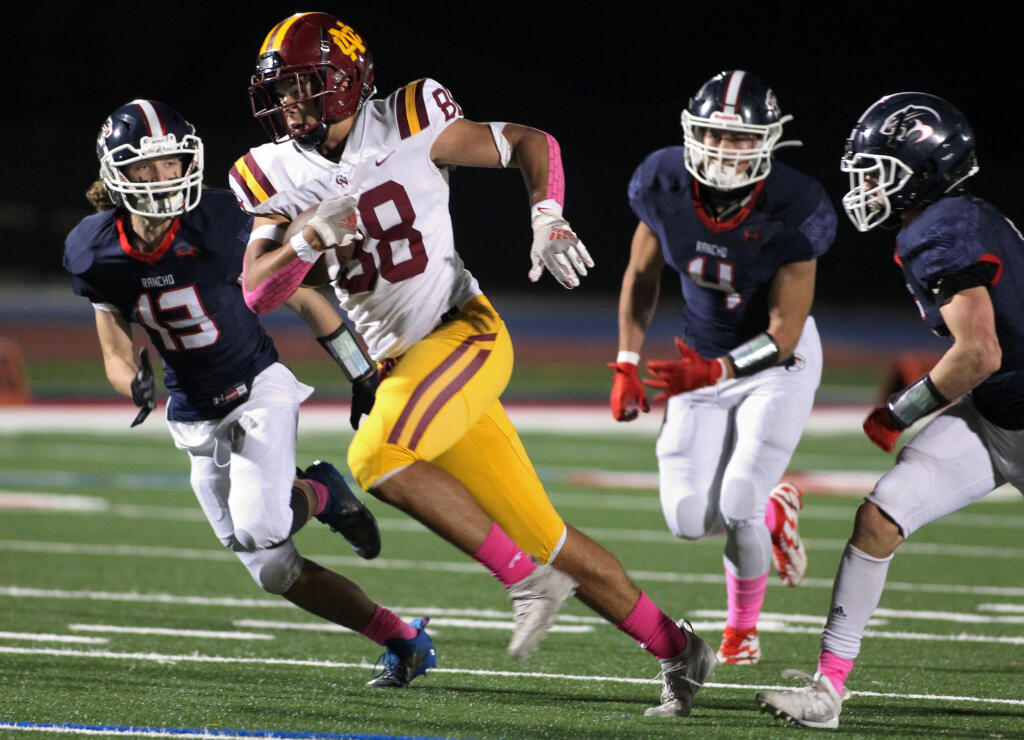 Cardinal Newman's Santiago Adan (88) runs for a big gain in the first half against Rancho Cotate, in football at Rancho Cotate High School, in Rohnert Park, Calif., on Friday, October 29, 2021. (Photo by Darryl Bush / For The Press Democrat)