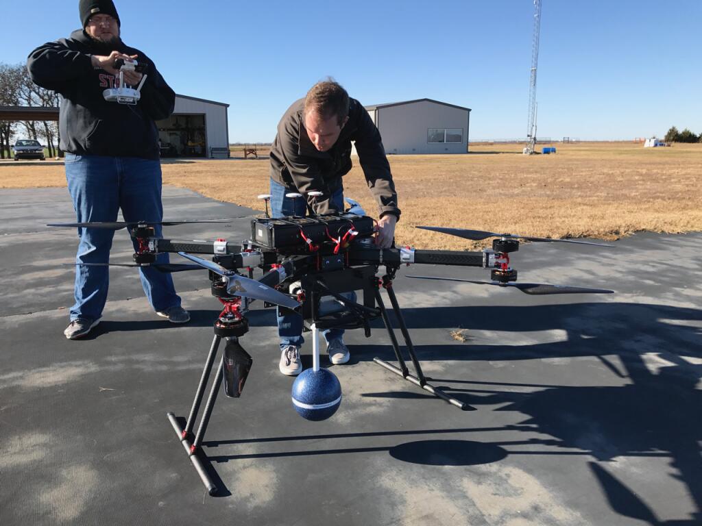 Unmanned Systems Research Institute engineers Dane Johnson and Taylor Mitchell are testing an ILS radio system onboard an unmanned aircraft at Stillwater, Oklahoma in December 2019. Photo by Jamey Jacob