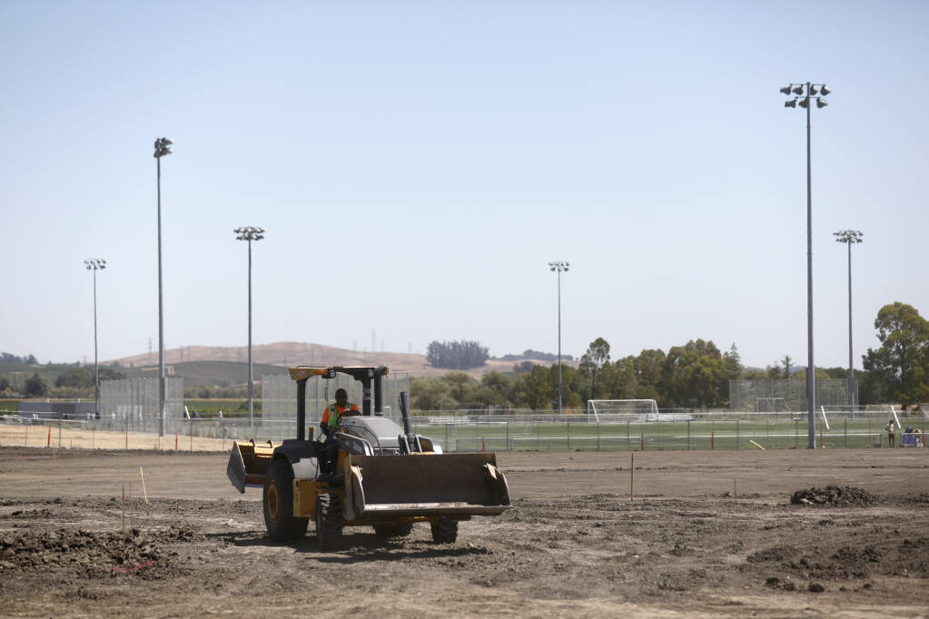 Lawrence Arlantico, an employee of O.C. Jones and Sons, Inc., drives a backhoe during construction of a baseball field, stands and snack bar at the Petaluma Community Sports Fields in Petaluma, Calif. on Wednesday, August 3, 2022. (Beth Schlanker/The Press Democrat)