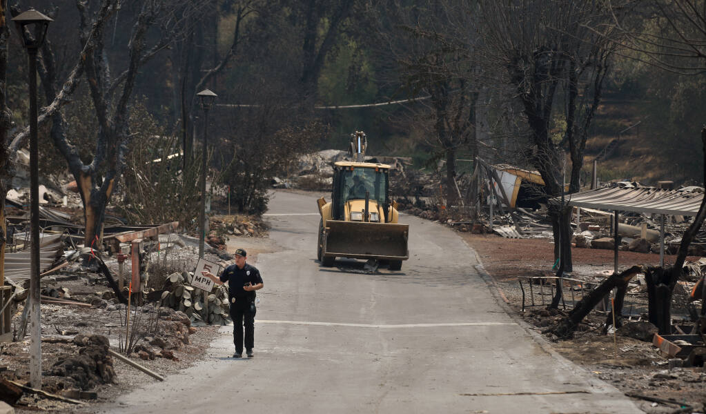 Clearlake Police Lt. Timothy Hobbs counts off the addresses of burned homes at the Creekside Mobile Home Park in Lower Lake, Thursday, Aug. 19, 2021. (Kent Porter / The Press Democrat)